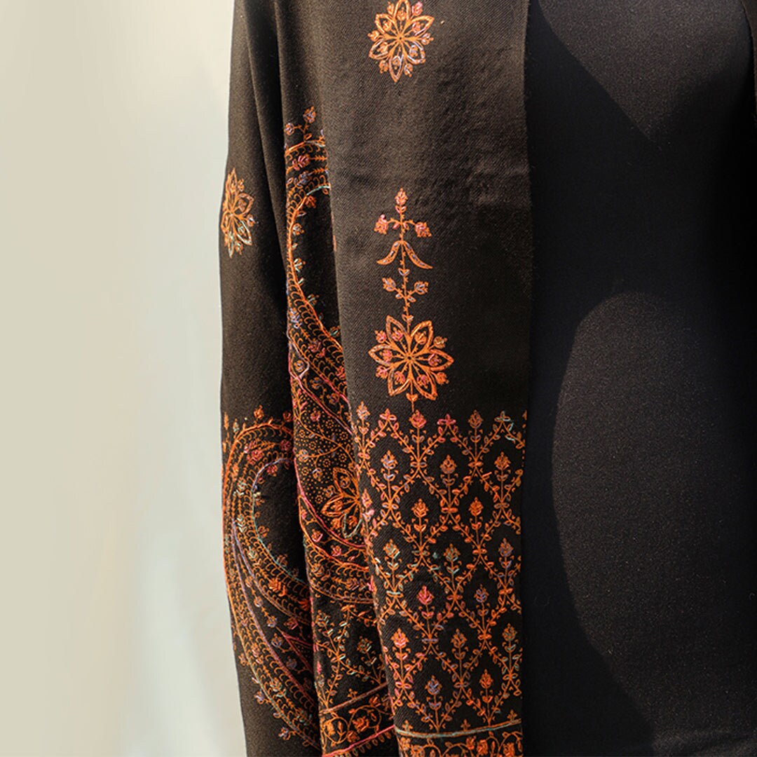 Black hand embroidered Kashmiri Pashmina wool shawl; Detailed subtle pink-rust-orange threadwork on high quality Cashmere wool; Full length