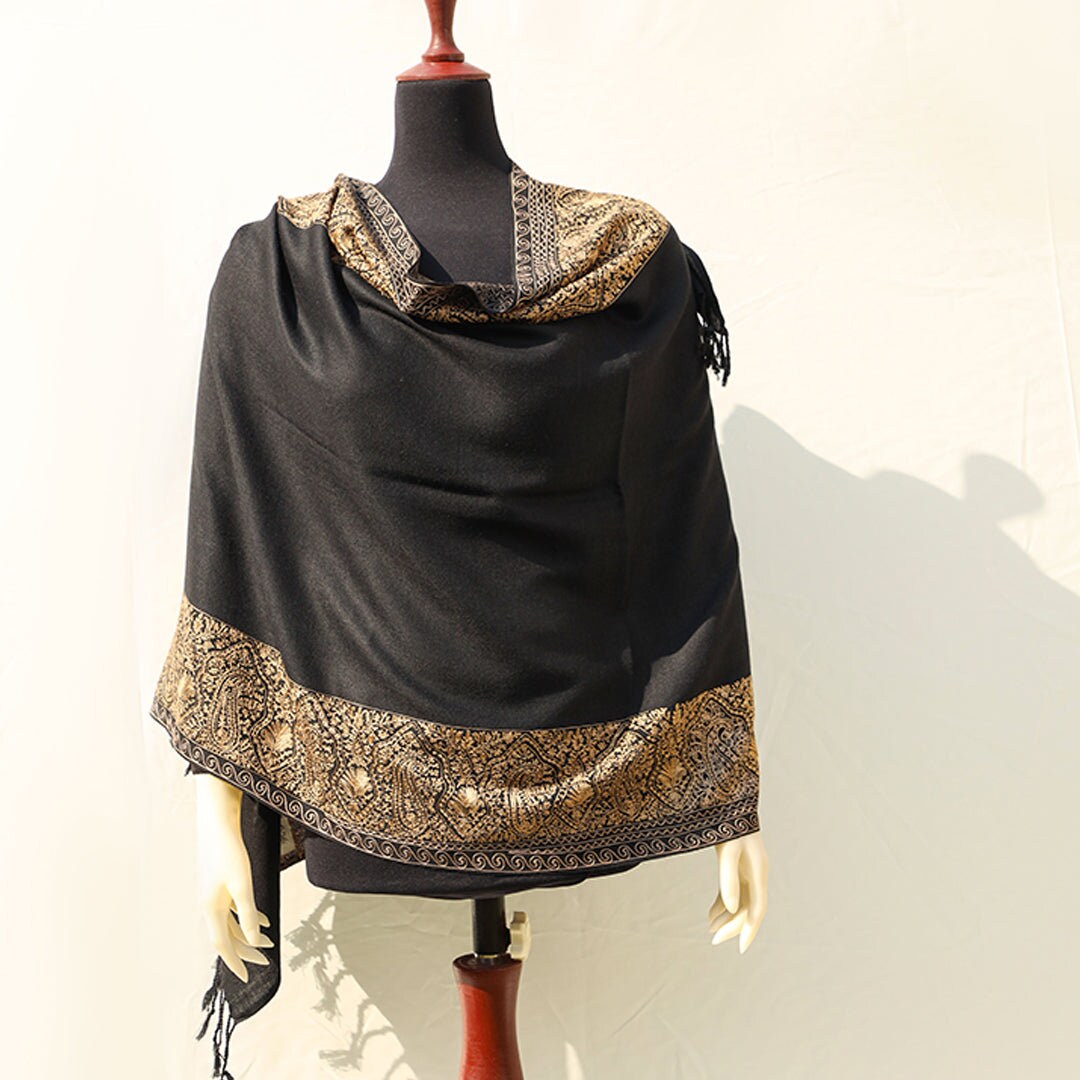 High quality pashmina wool shawl in Black pure wool base, with extensive border embroidery in golden color; fine machine-work with paisley p