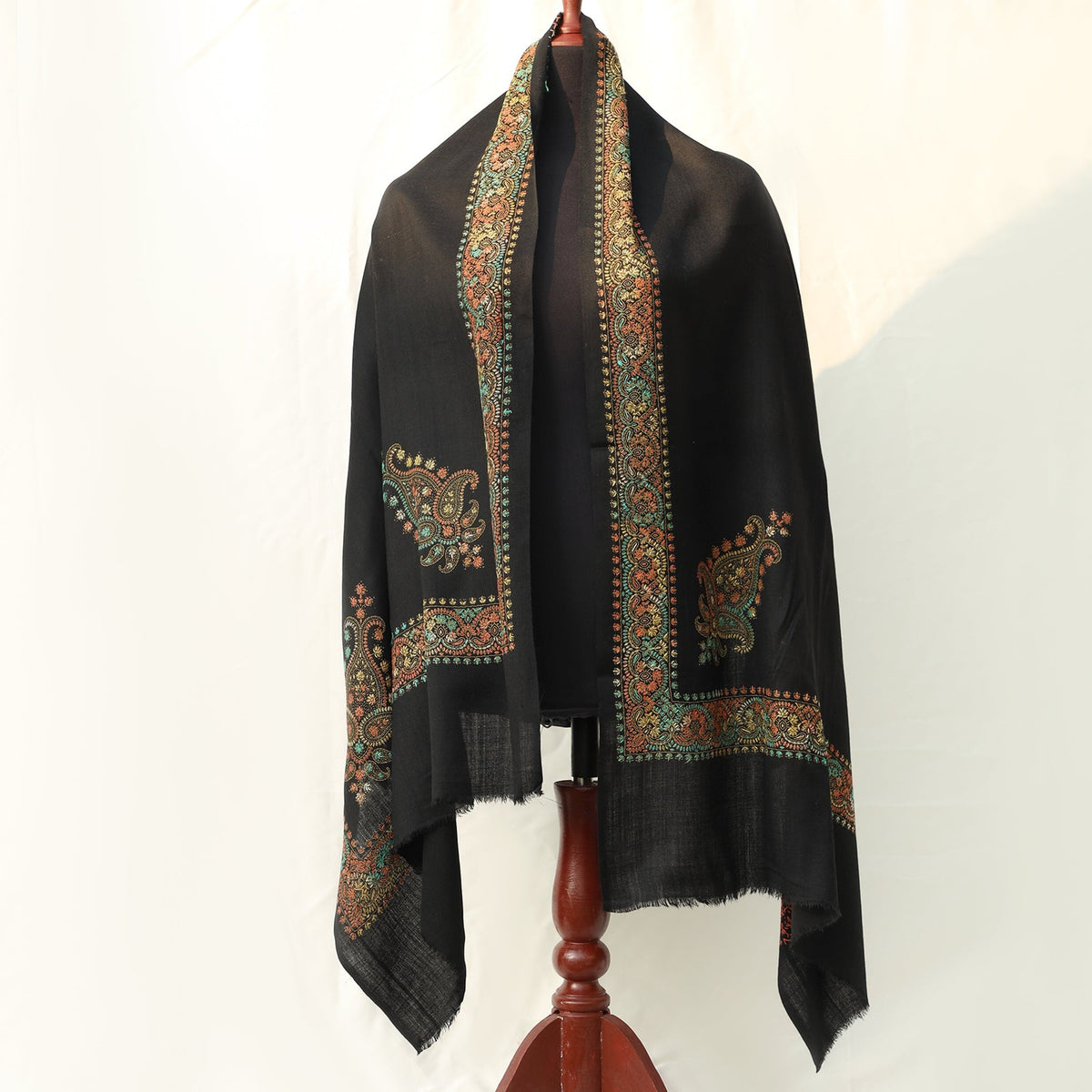 Mustard or Black colored pashmina wool shawl with intricate hand embroidery in subtle yet bold colors with paisley motifs on the border; Pas