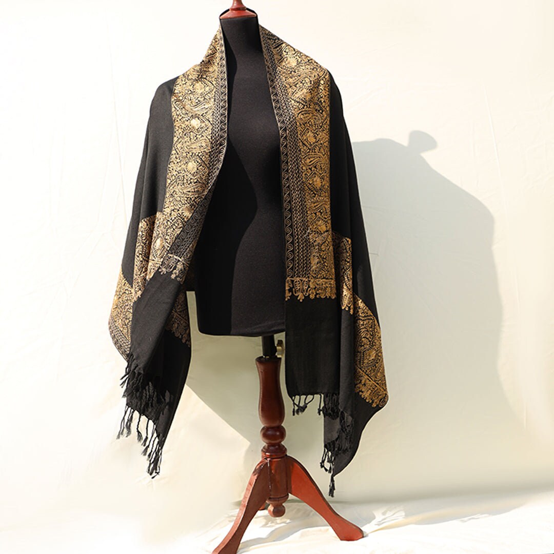 High quality pashmina wool shawl in Black pure wool base, with extensive border embroidery in golden color; fine machine-work with paisley p