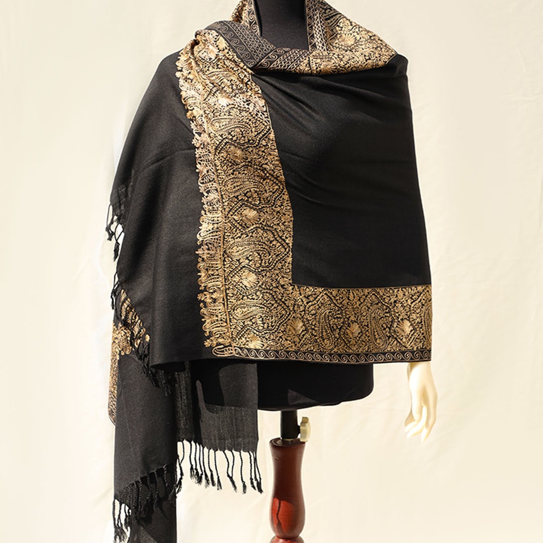 High quality pashmina wool shawl in Black pure wool base, with extensive border embroidery in golden color; fine machine-work with paisley p