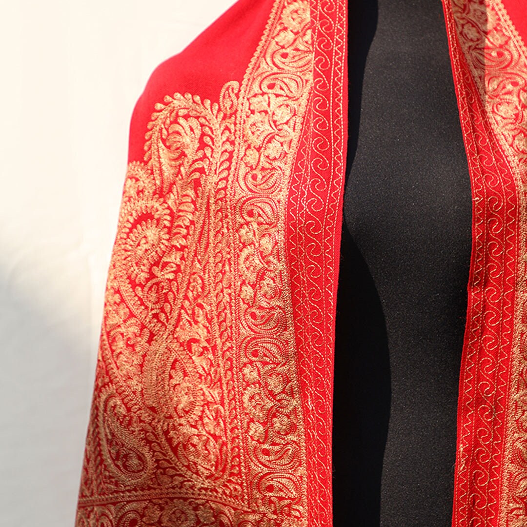 Bright red pashmina shawl with paisley embroidery in golden; Intricate embroidery all across the shawl; From Kashmir