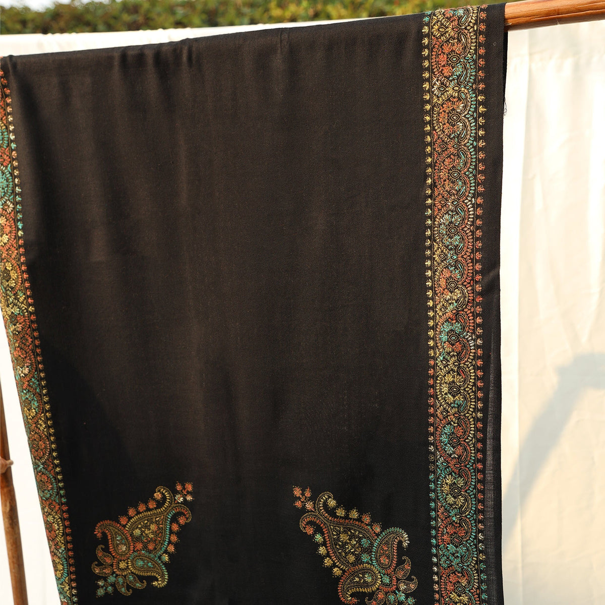 Mustard or Black colored pashmina wool shawl with intricate hand embroidery in subtle yet bold colors with paisley motifs on the border; Pas